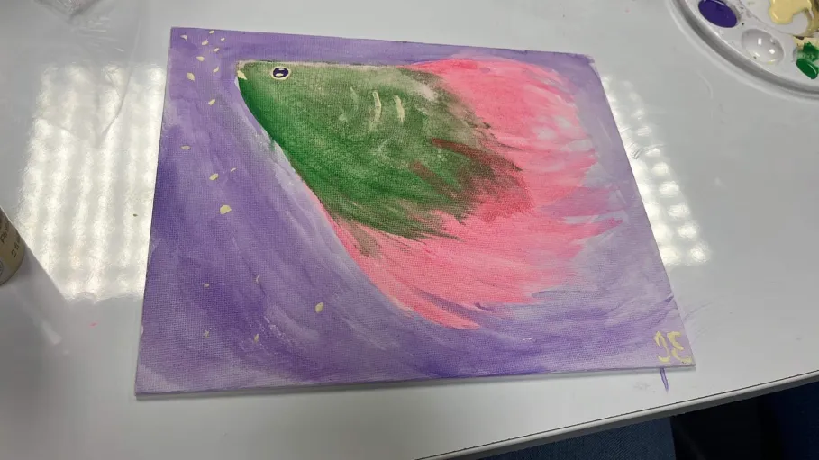 a painting of a pink and green betta fish eating fish food in purple water
