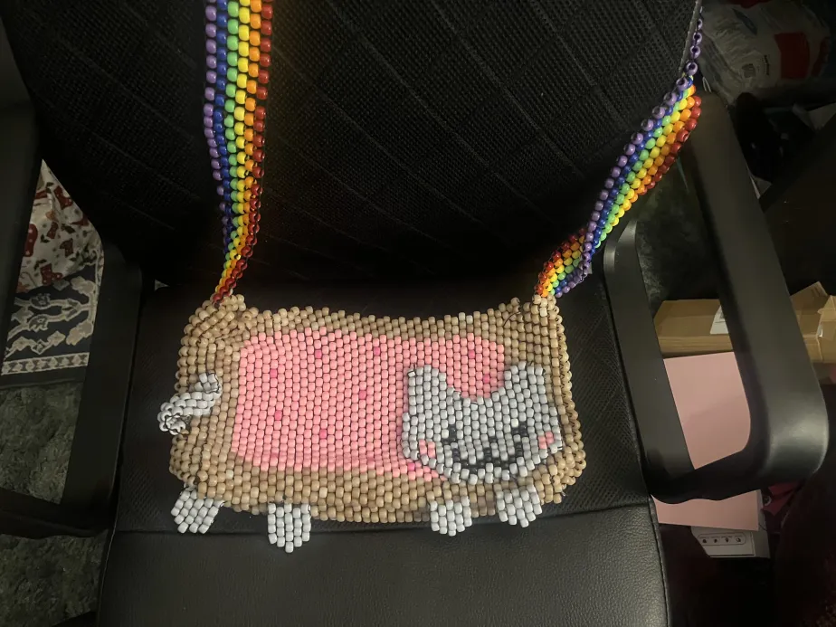 A kandi purse shaped like Nyan Cat