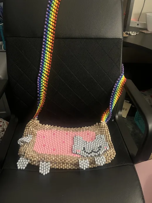 A kandi purse shaped like Nyan Cat