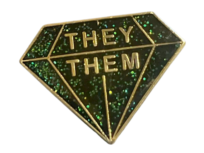Pin shaped like a faceted gem that reads 'they them'.