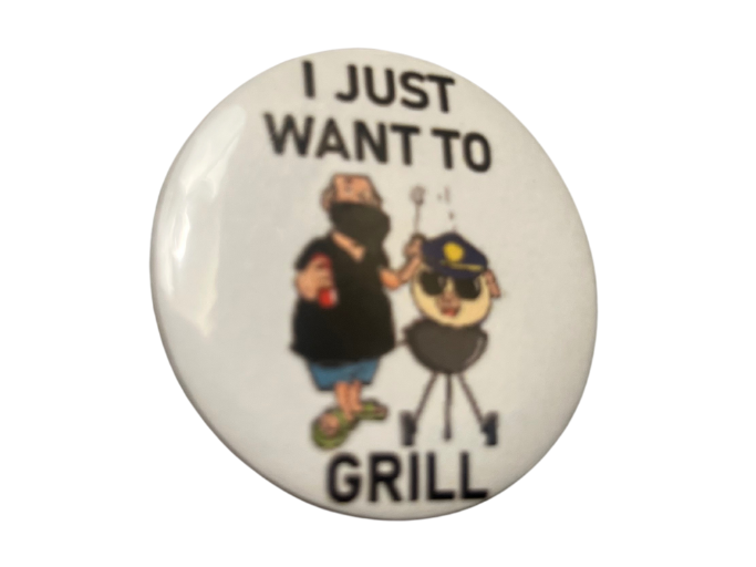 a button that reads 'i just want to grill,' featuring a man cooking a pig dressed as a cop on a barbecue