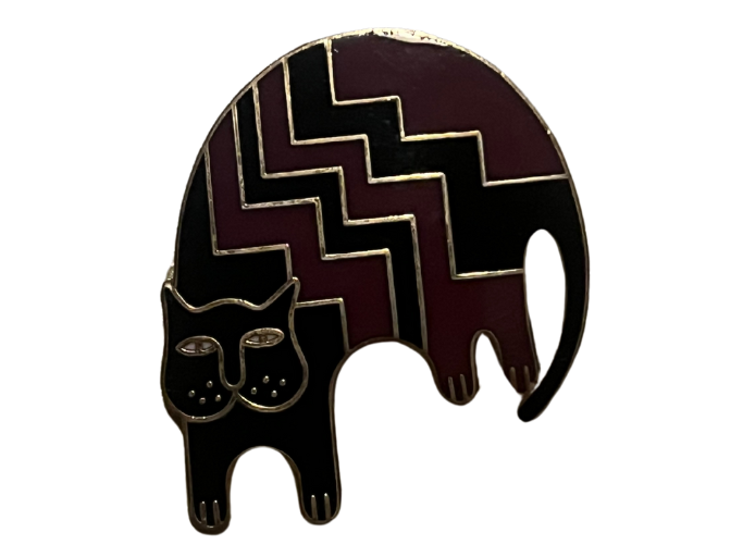 an enamel pin of a a purple and black striped cat.