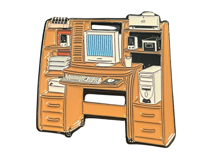 an enamel pin resembling a 1990s to 2000s home computer desk.