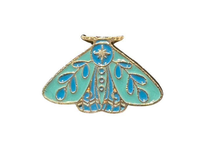 an enamel pin of a blue and green moth.