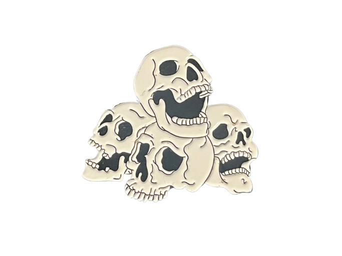 an enamel pin of a pile of four skulls.