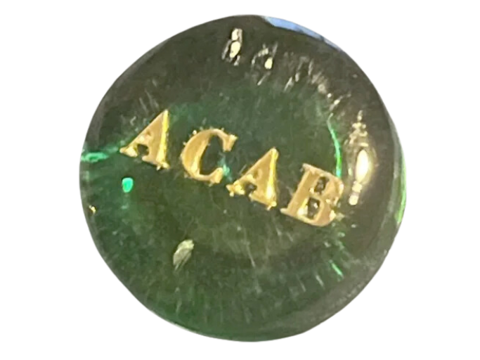 A green pin that reads 'ACAB'.